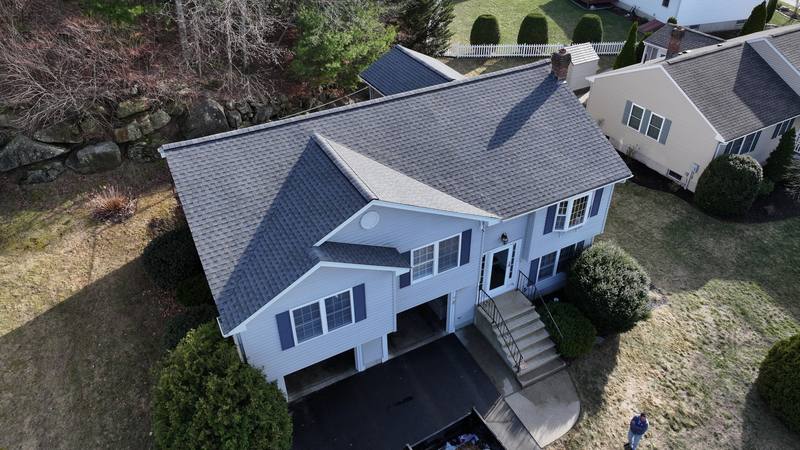 Split-level home with a gray shingle roof