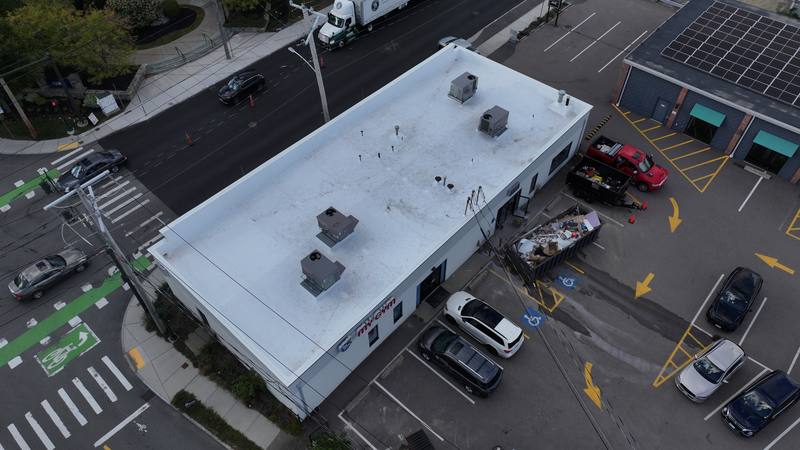 Commercial building with a white flat roof, aerial view