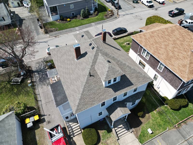 Hip roof with a brick chimney on a two-family home