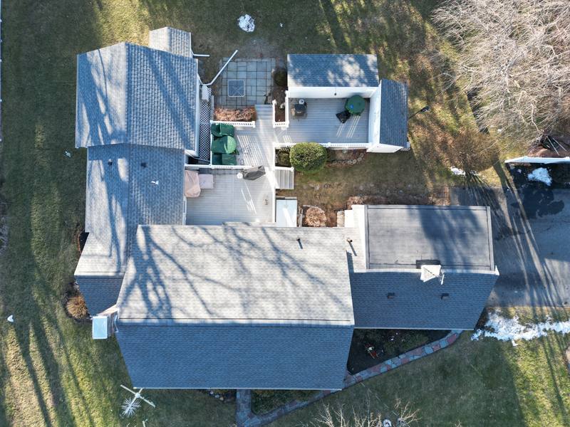 Gray shingle roof on a courtyard home in late winter