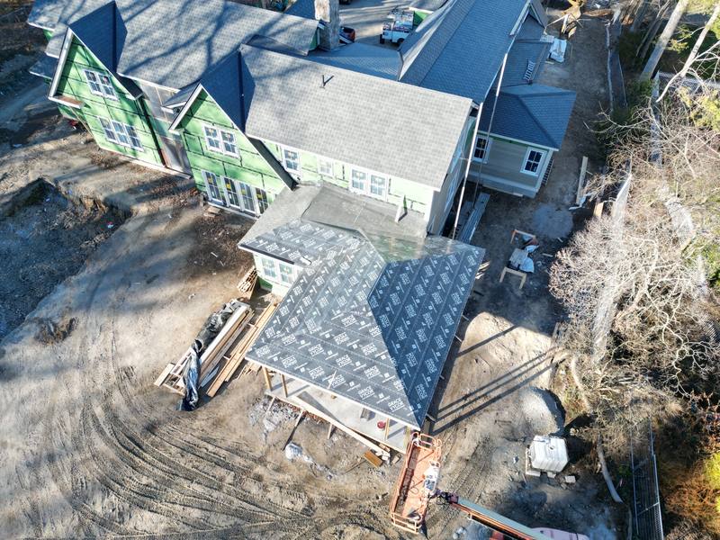 New construction with a porch roof and white trim going on